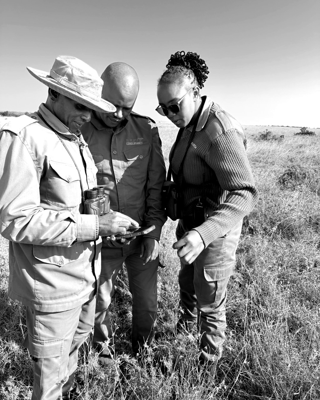Rangers and guides at work in the field, in black and white